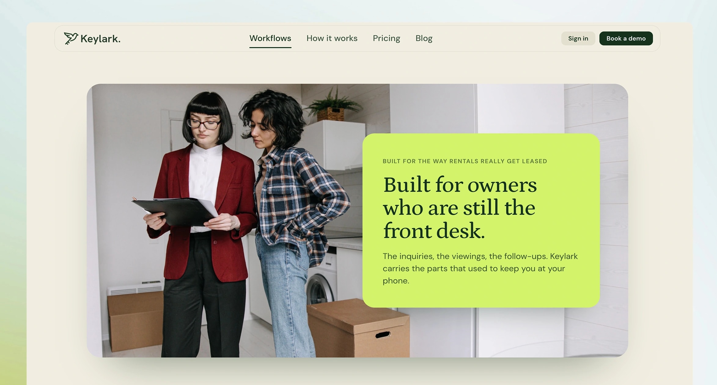 Built for owners who are still the front desk, over a photograph of two people reviewing a lease in an apartment.